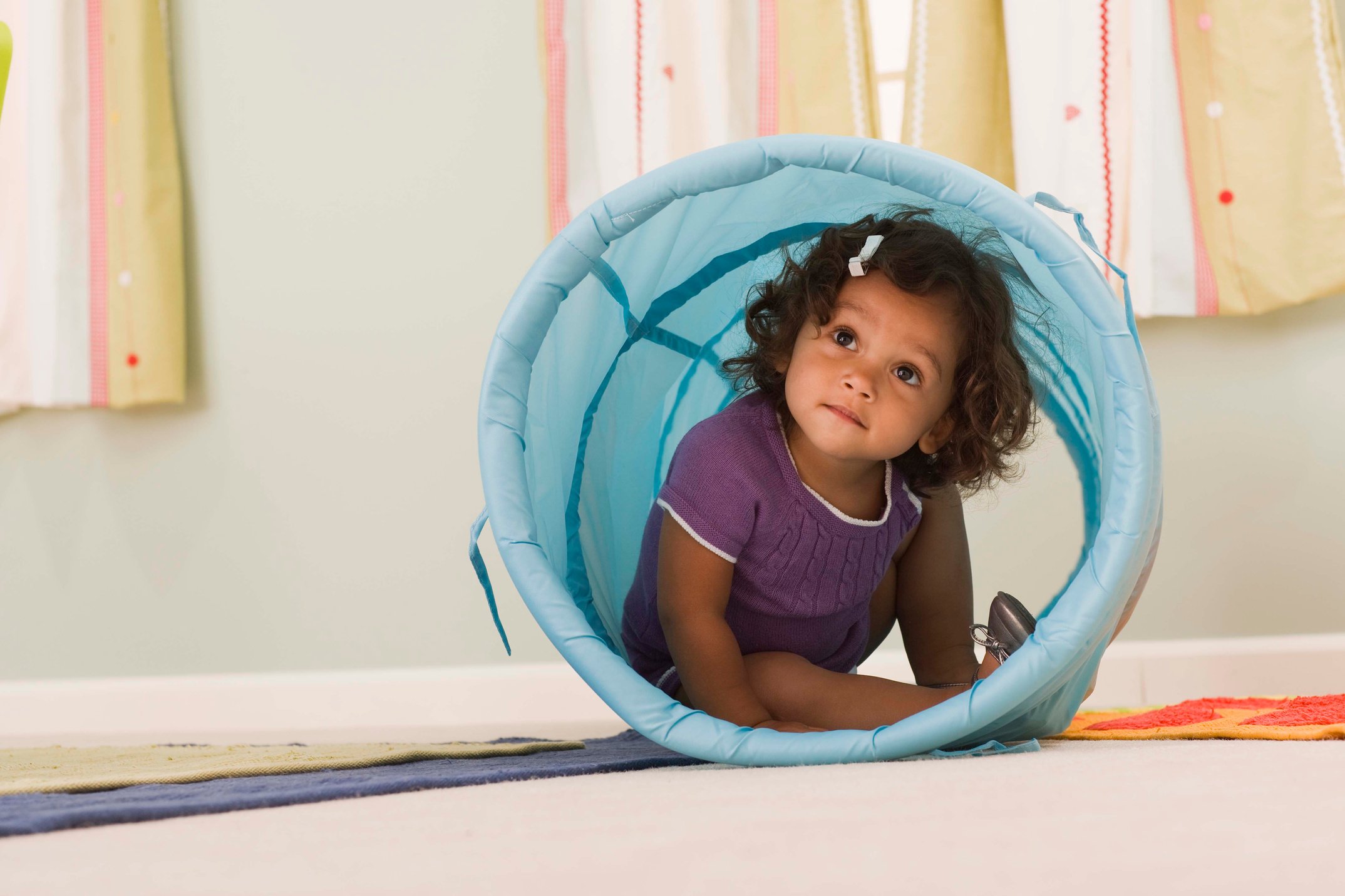 Toddler inside a toy tunnel